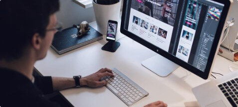 man designing a mobile app on computer