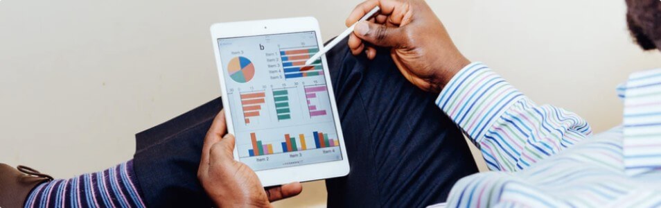 man looking at stats in a presentation on tablet